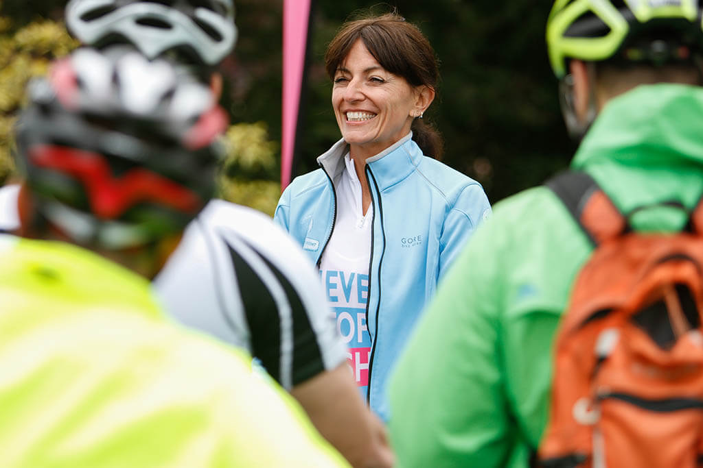 Davina McCall smiling while getting ready for a bike ride