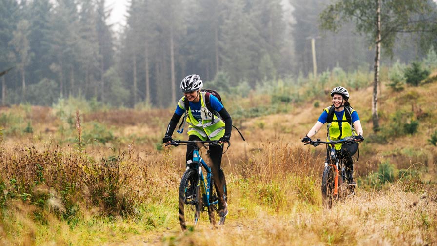 cyclists riding across moorland