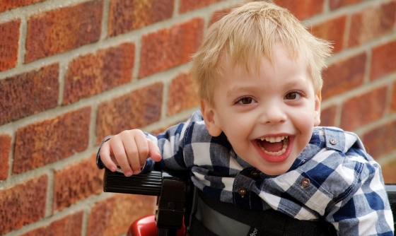 Young boy in electric wheelchair