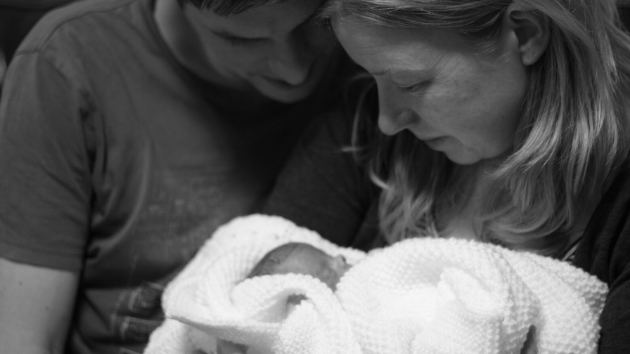 Elijah in hospital being cuddled by his parents