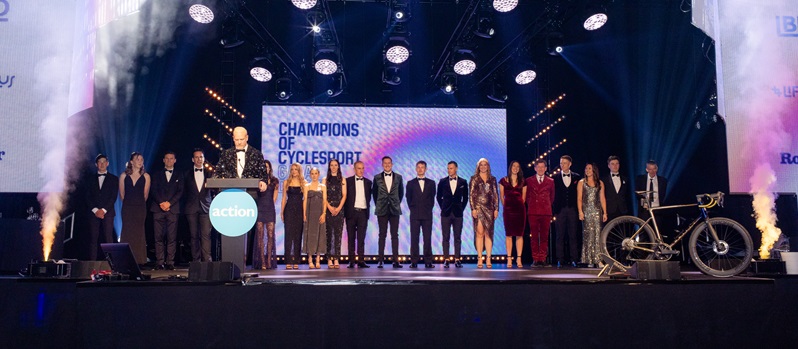 Champions of Cyclesport standing in a line on the stage at the event.