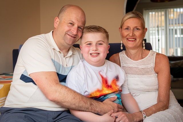 Digby with his parents smiling to camera