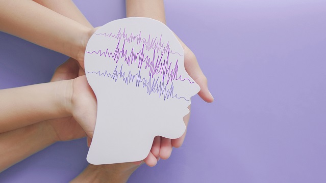 Image showing electrical brain activity on a printed head shape to illustrate epilepsy.
