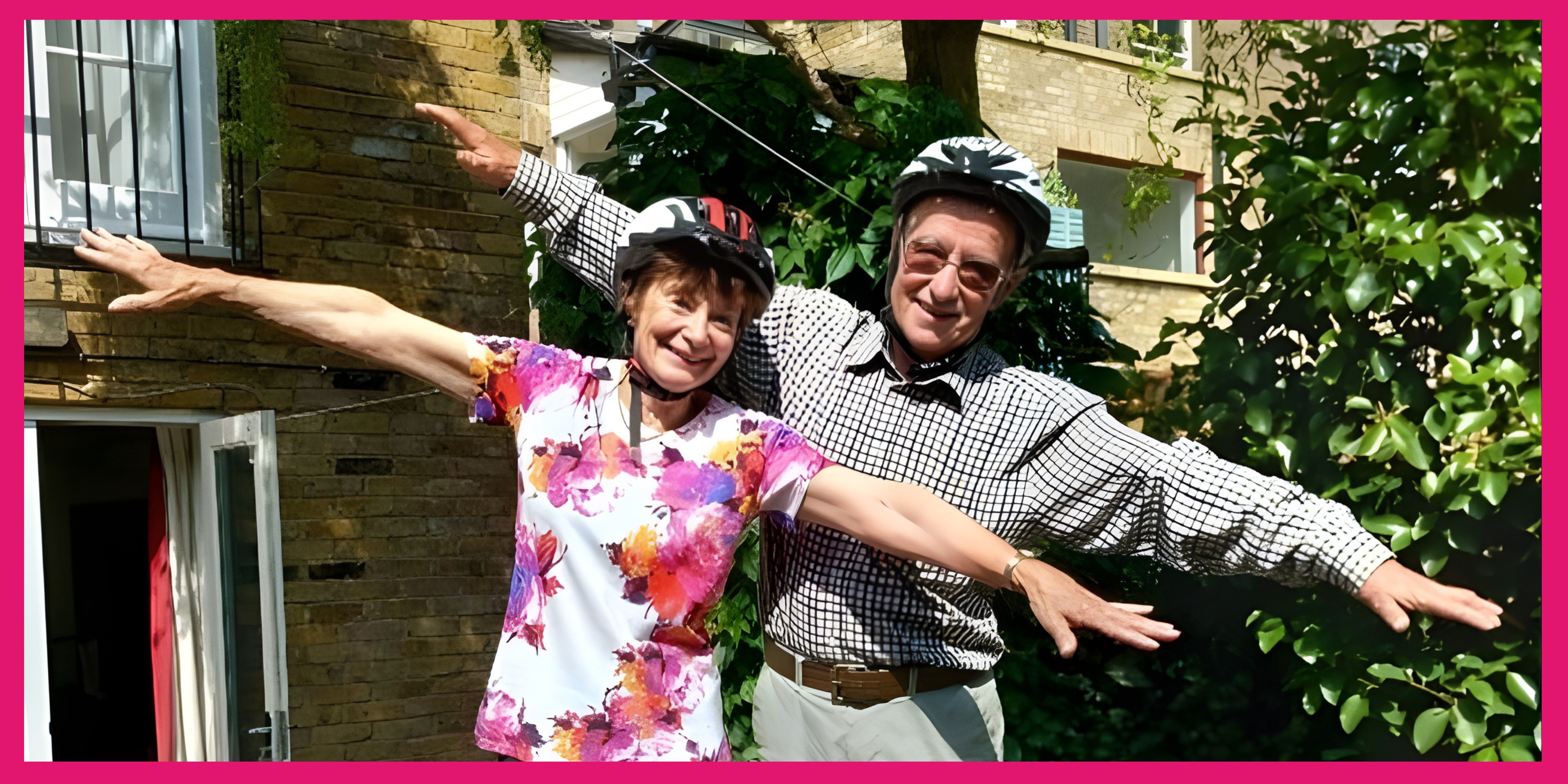 A couple wearing safety helmets imitating flying