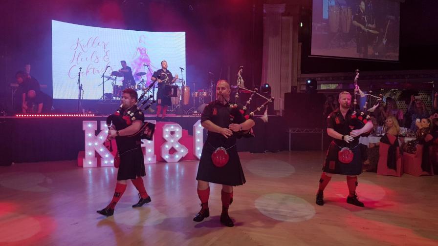 Men playing bagpipes on the dance floor at the Killer Heels and Cocktails fundraiser.