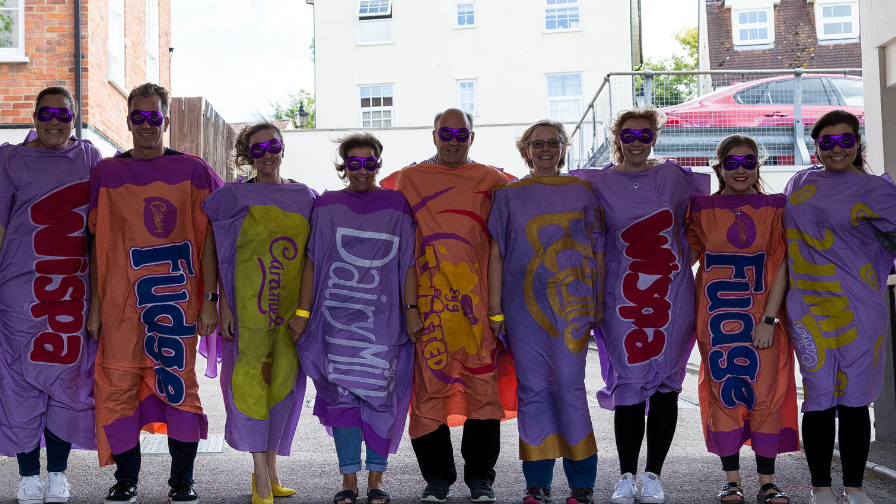 Group of colleague dressed as purple chocolate bars
