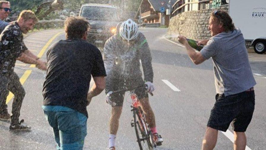 anthony being sprayed with champagne as he finishes his challenge