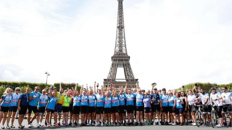 group celebrating in front of the Eiffel tower