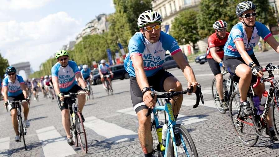 cyclists riding down the champs-elysees