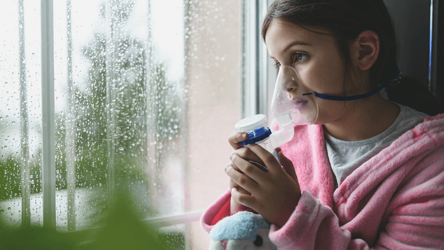 A young child using an inhaler