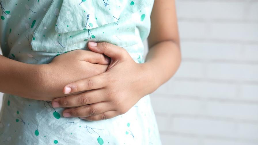 Girl with hands on stomach to show pain