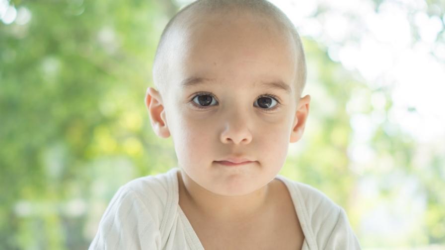Toddler-aged child who has lost their hair due to cancer treatment.