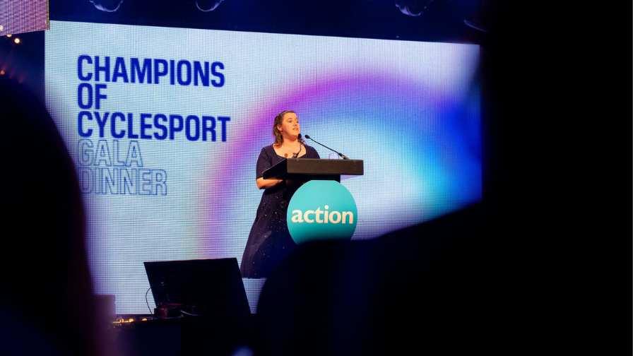 Image of family speaker Louise on stage telling her story