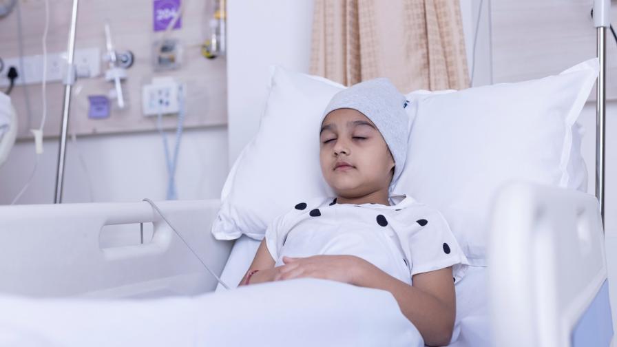 Very sick child laying in hospital bed.