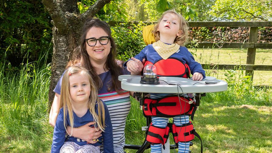 Emmy in the garden with Mum and sister