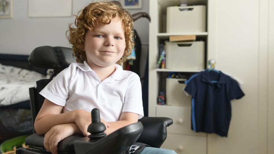 Boy, aged around 8, in an electric wheelchair