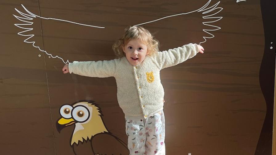 Eva holding both arms out to compare her wingspan to a buzzard.