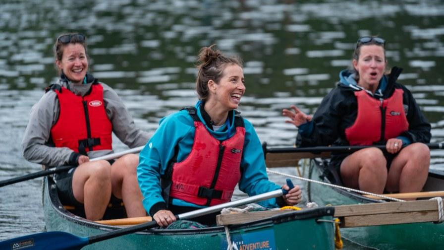 A group paddling around Coniston Water in a canoe