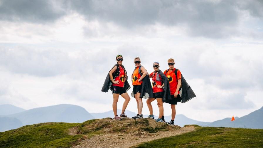 Hikers celebrating on the top of a mountain