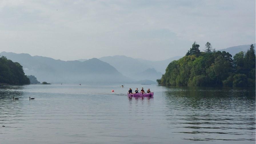 A view of the lake with kayakers on it