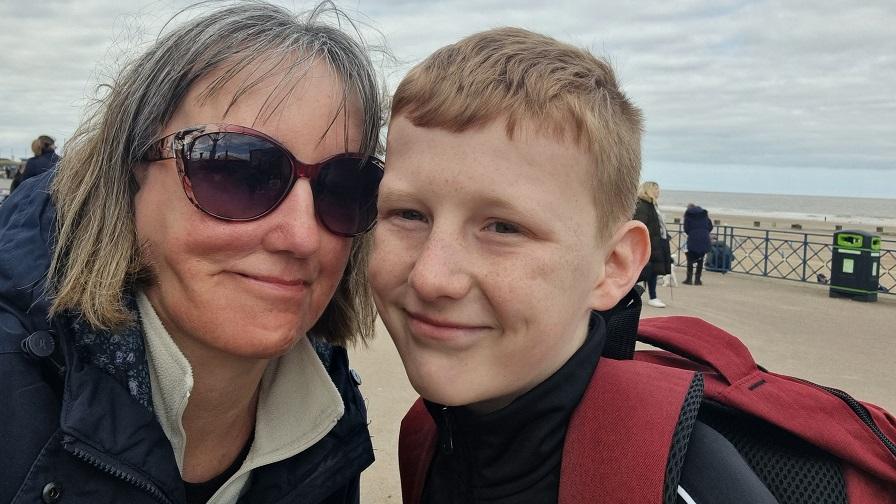 Oscar with his mu, Jo, on the seafront.