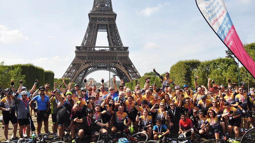 group of riders under the eiffel tower