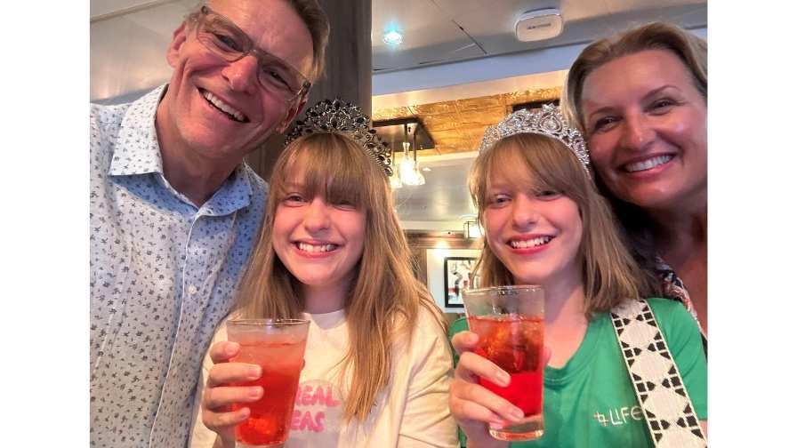 Image of Malcolm with his wife and daughters