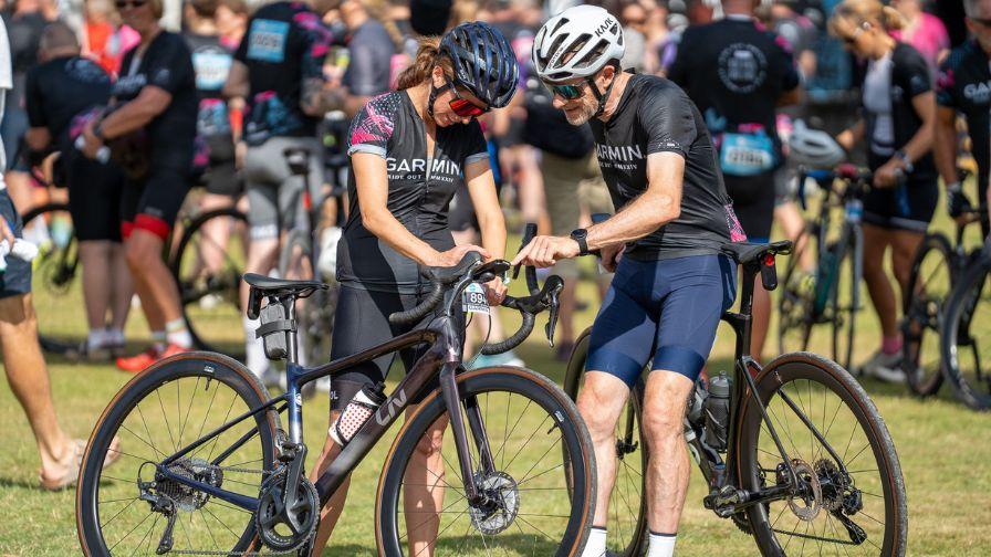 cyclists setting garmin device on bike