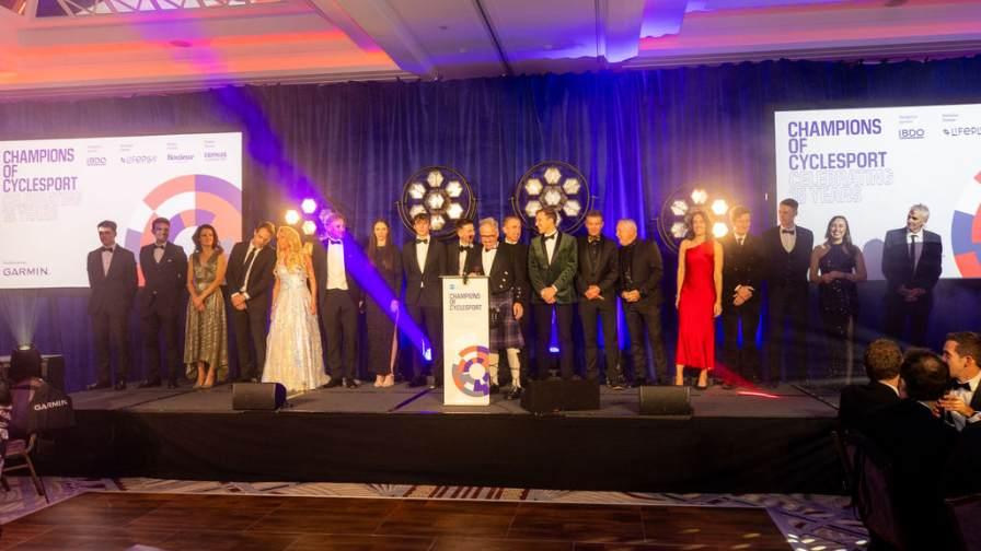 Champions line up on stage