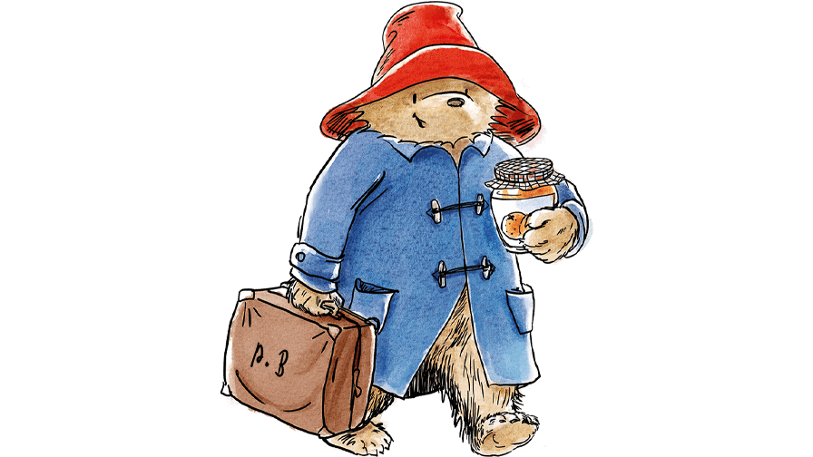 Paddington Bear in his blue raincoat and red hat, carrying his suitcase with a jar of marmalade under his arm