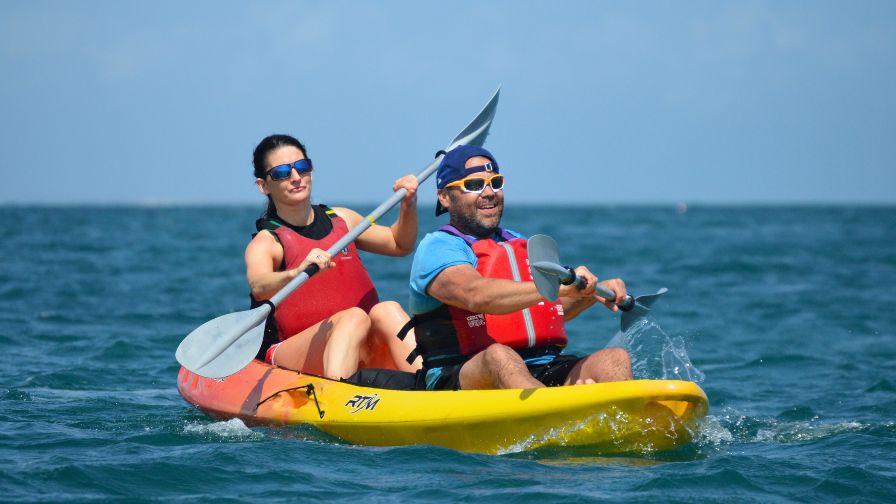 couple paddling in swanage bay