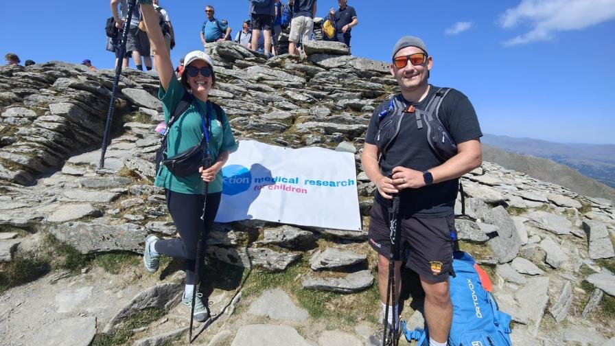 Hikers posing at the highest point of the hike