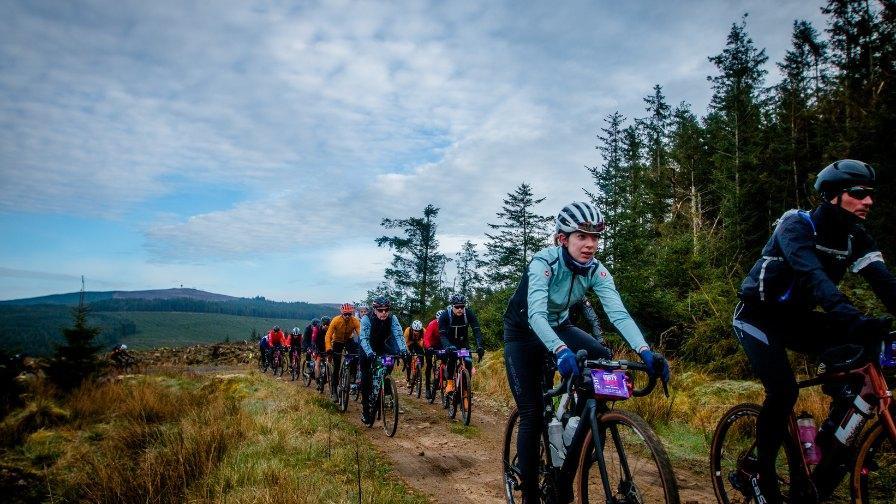 A group of cyclists on a gravel track