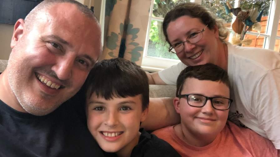 Image of family of four smiling - the Webbers