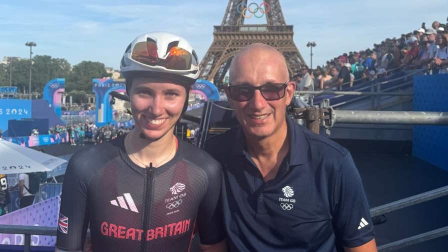 Image of Pfeiffer and Peter Georgi smiling in front of the Eiffel Tower