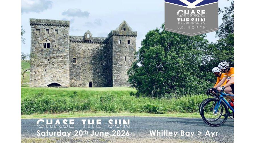 cyclists on chase the sun passing by and looking at a historical castle