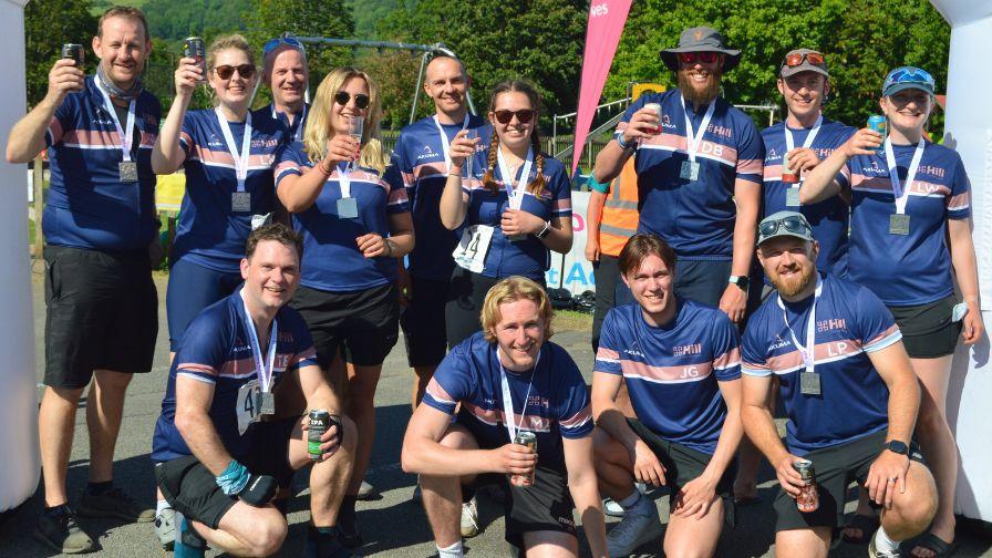 A large group of people in identical athletic shirts and finishers