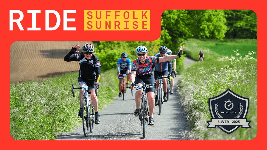 Cyclists wave while riding along a rural path on a sunny day. Top left text reads "RIDE SUFFOLK SUNRISE" on a red background