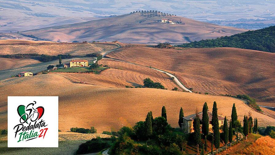 Rolling Tuscan hills with rustic farmhouses and cypress trees, featuring a Pedalata Italia logo in the bottom-left corner.