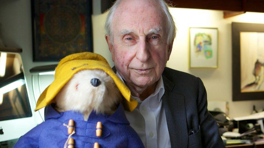 Michael Bond holding Paddington Bear
