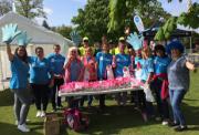 A group of Action volunteers posing for a photo at a sunny Action event