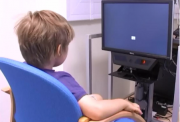 Young boy using eye tracking machine