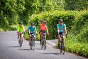Team of four cyclists on riding part of a road route