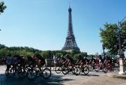 peloton riding on closed roads in front of the eiffel tower