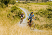 Two riders biking through the terrain of the Lake District