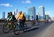 cyclists riding past canary wharf