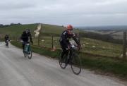 cyclists riding along the crest of a hill in the wessex downs