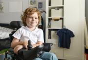 Boy, aged around 8, in an electric wheelchair