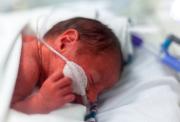 Premature baby with breathing tubes