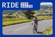 solo cyclist riding through the yorkshire dales with hills and fields in the background